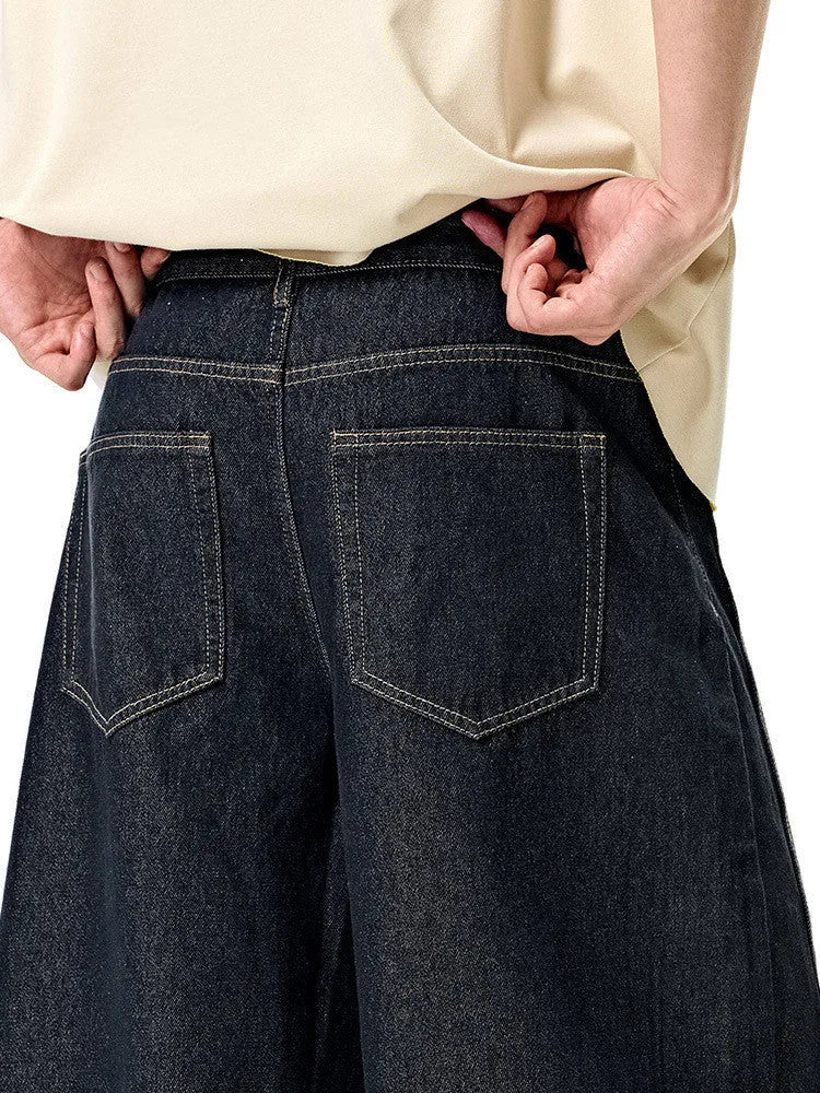 Men's original cow colour wide leg denim trousers laid flat.