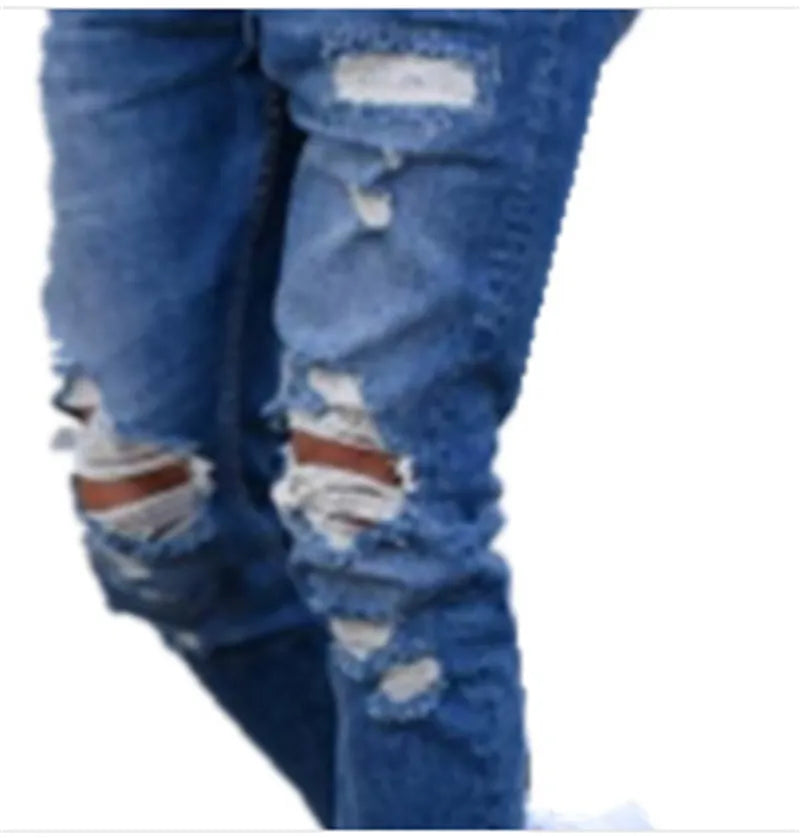 Men's deep blue cotton jeans with distressed hole detailing laid flat.