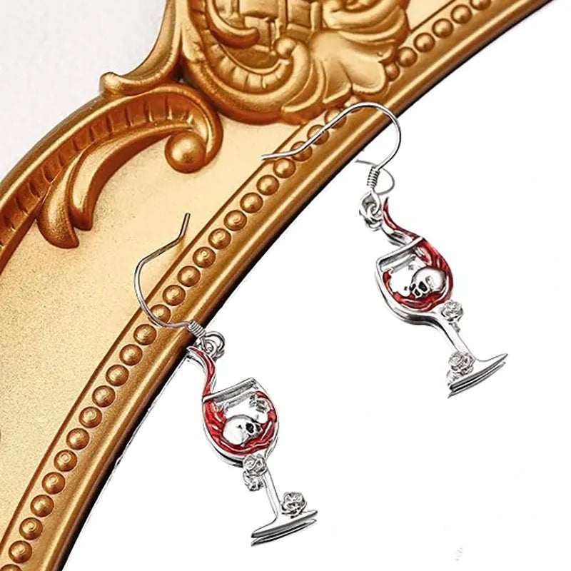 A pair of zinc alloy electroplated earrings depicting a skull inside a wine glass shape.