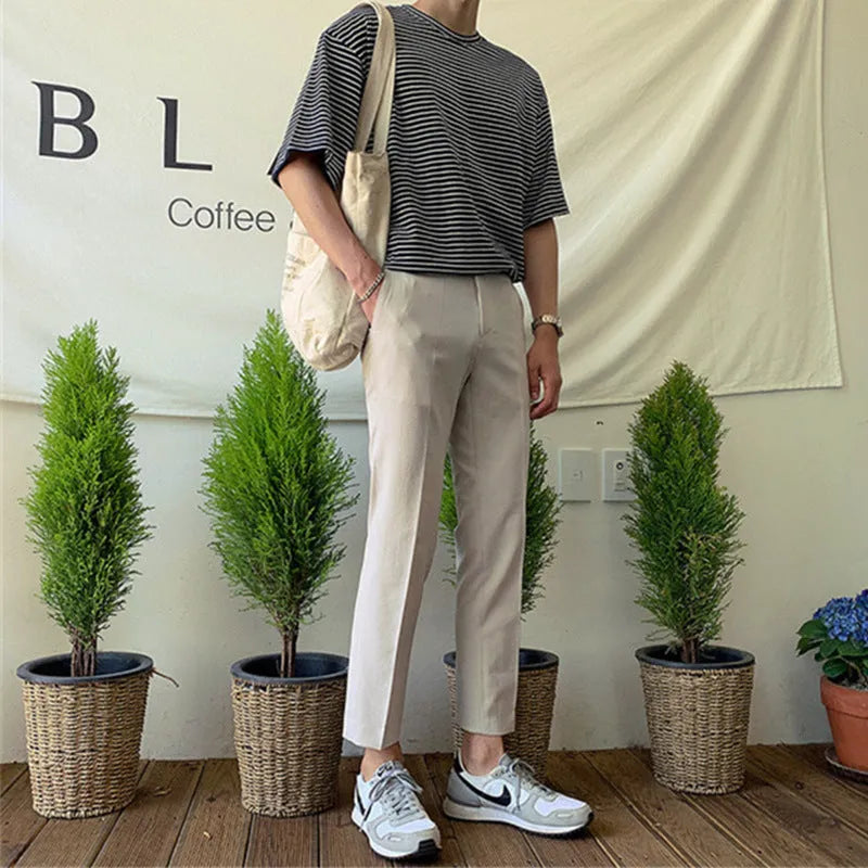 Men's slim straight-leg cotton trousers in black with a drawstring waist.