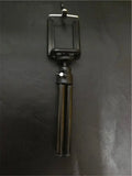 Black and silver desktop phone holder with two-section bracket on a desk.