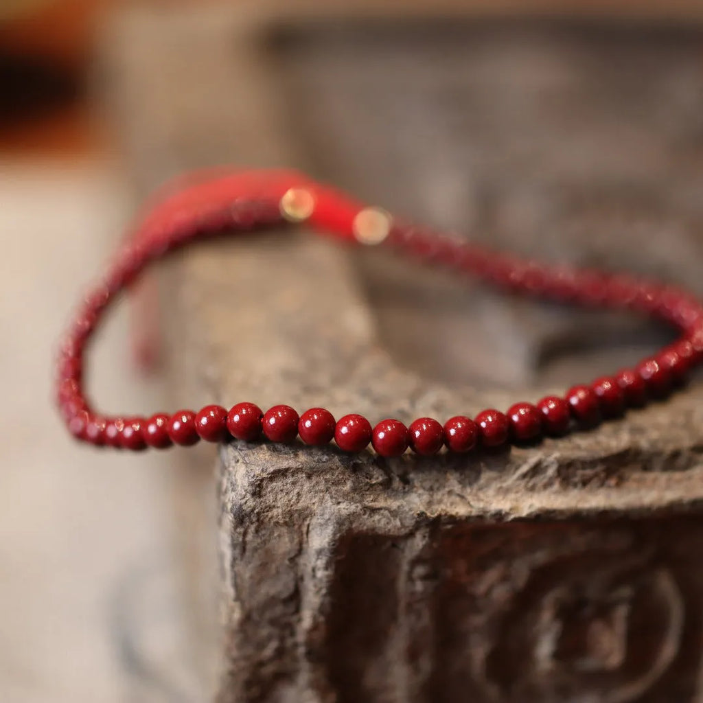 Women's handmade cinnabar bracelet with purple gold sand design and Chinese auspicious patterns.