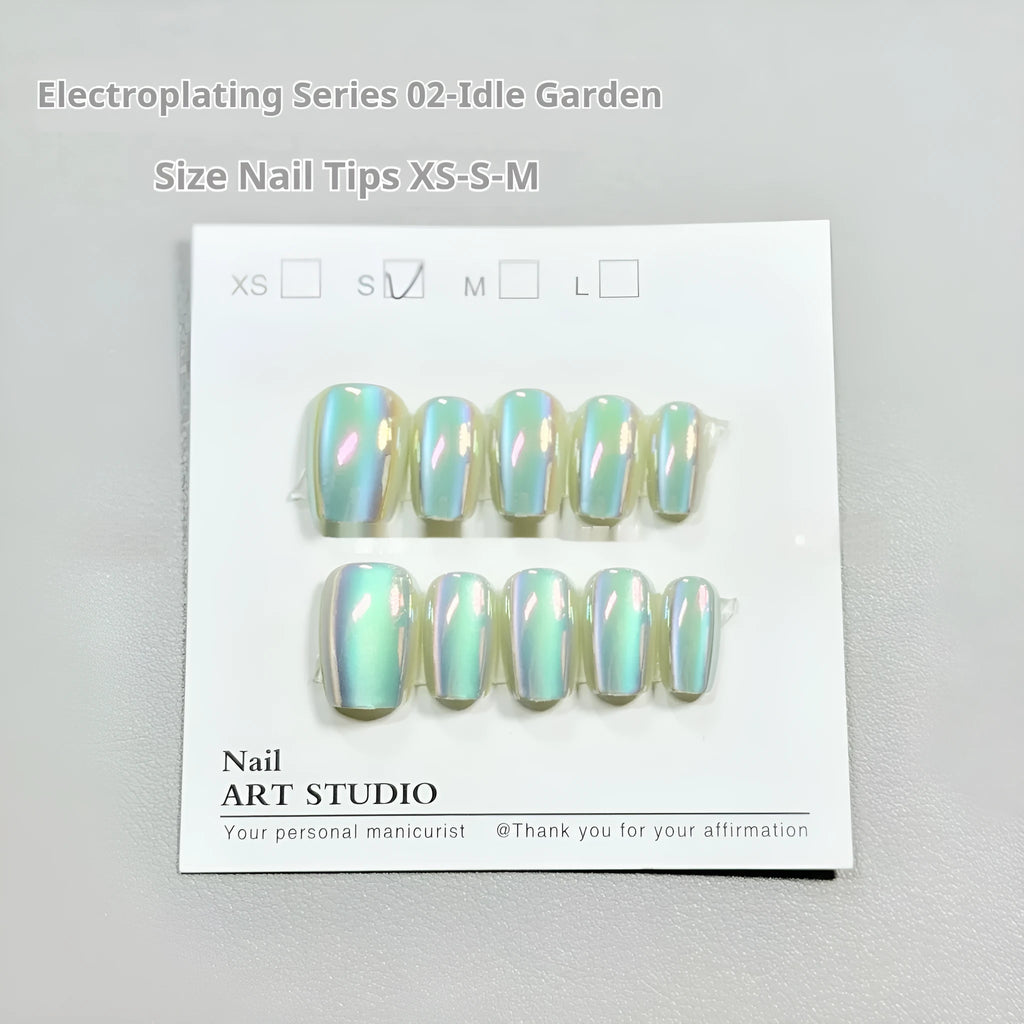 Set of electroplated Cat's Eye false nails with aurora armour finish in short ladder shapes, sizes XS, S, and M.