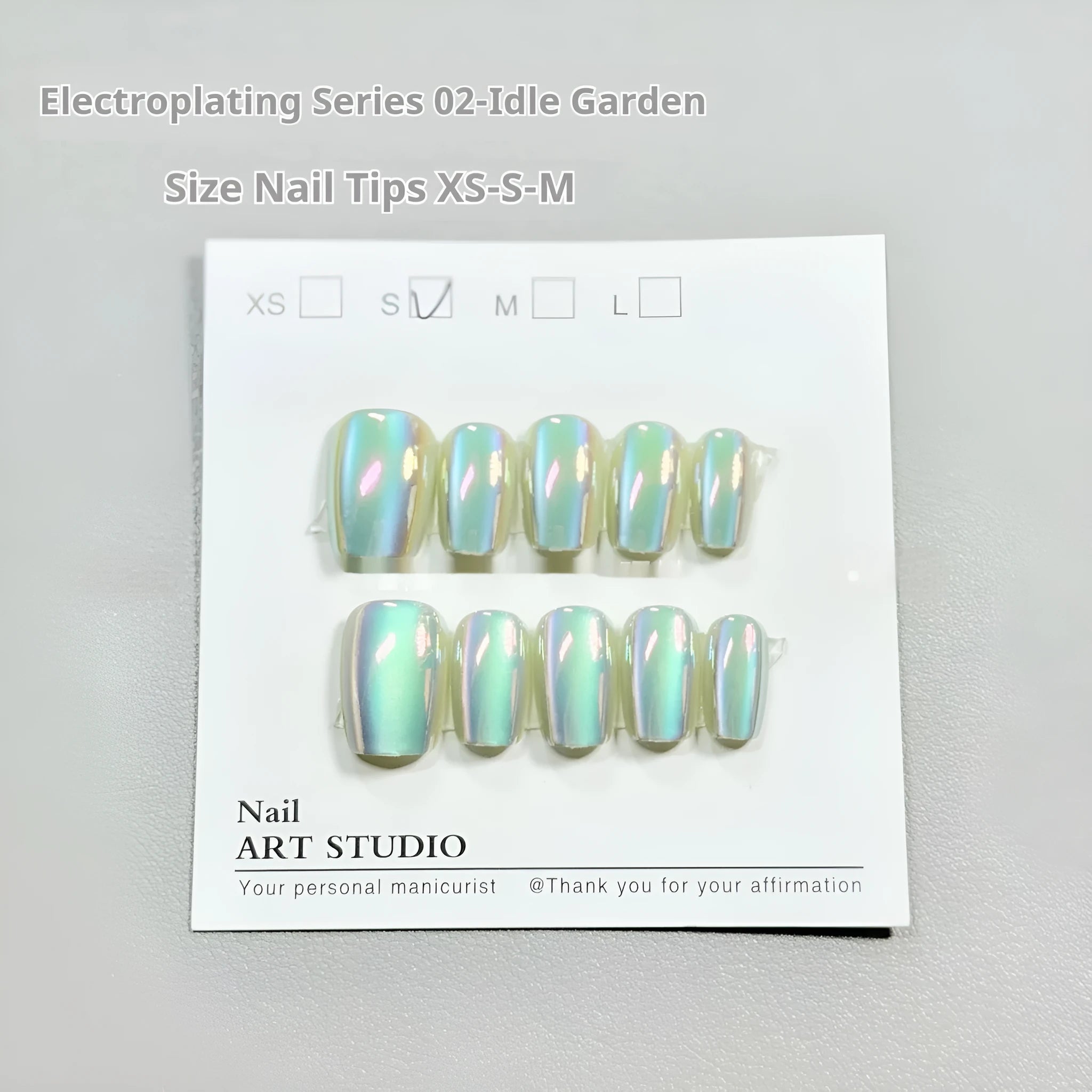 Set of electroplated Cat's Eye false nails with aurora armour finish in short ladder shapes, sizes XS, S, and M.