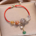 Women's hand-woven bracelet with crystal and sequins on a peace buckle clasp, shown in red, green, and blue colours.