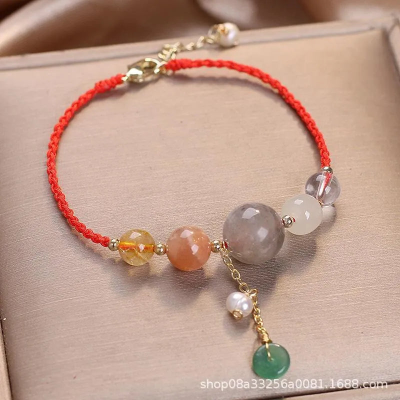 Women's hand-woven bracelet with crystal and sequins on a peace buckle clasp, shown in red, green, and blue colours.