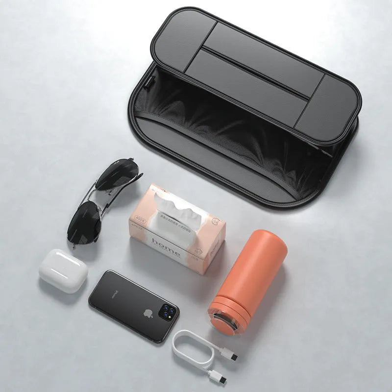Black leather car seat rear storage bag with compartments, shown mounted on a car seat.