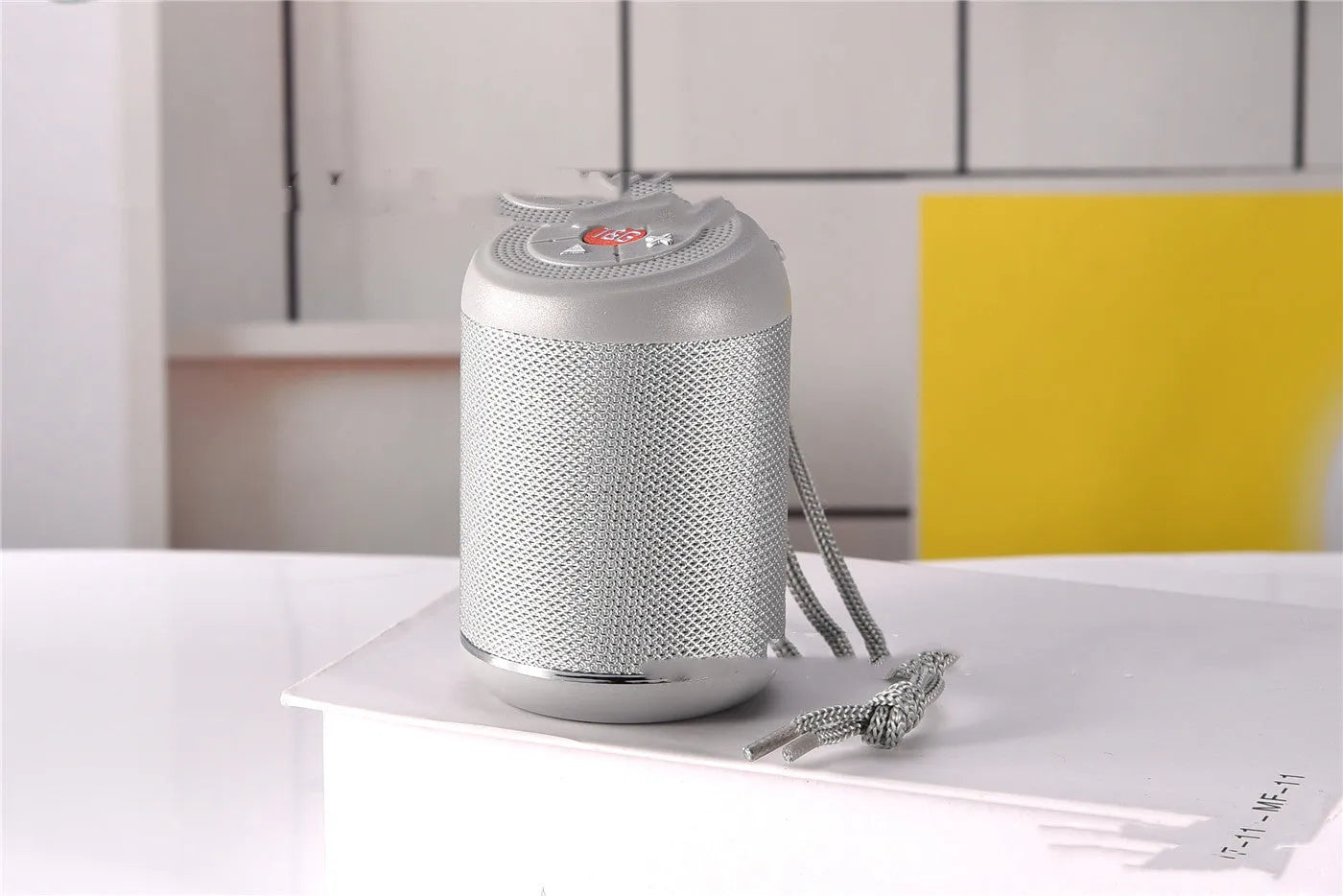 Portable outdoor Bluetooth subwoofer speaker in multiple colour options showing button controls.