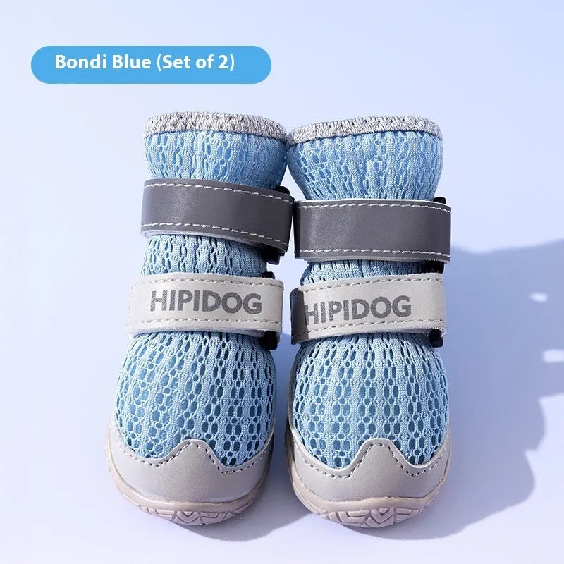 Pair of light blue cartoon-style dog shoes on a white background for summer paw protection.
