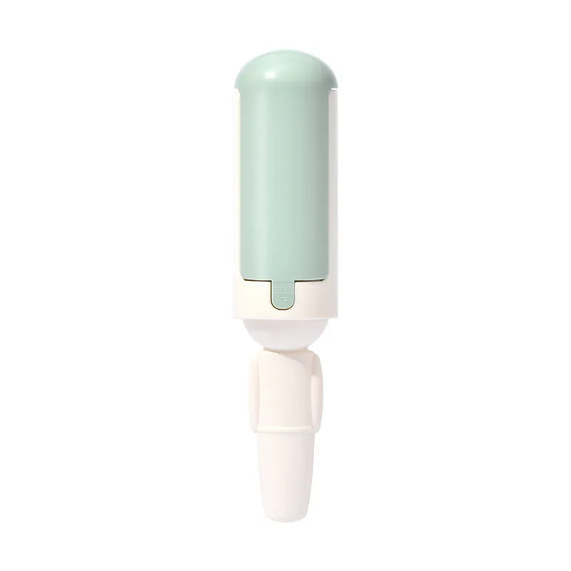 White and green pet hair removal roller with self-cleaning base on a carpet