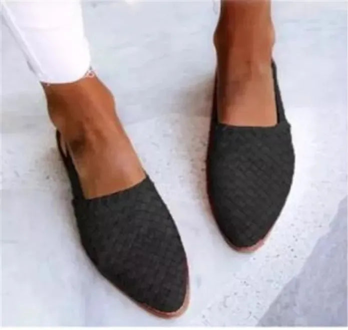 Pointed-toe flat casual sandals with a buckle strap on a microfiber upper and rubber sole.