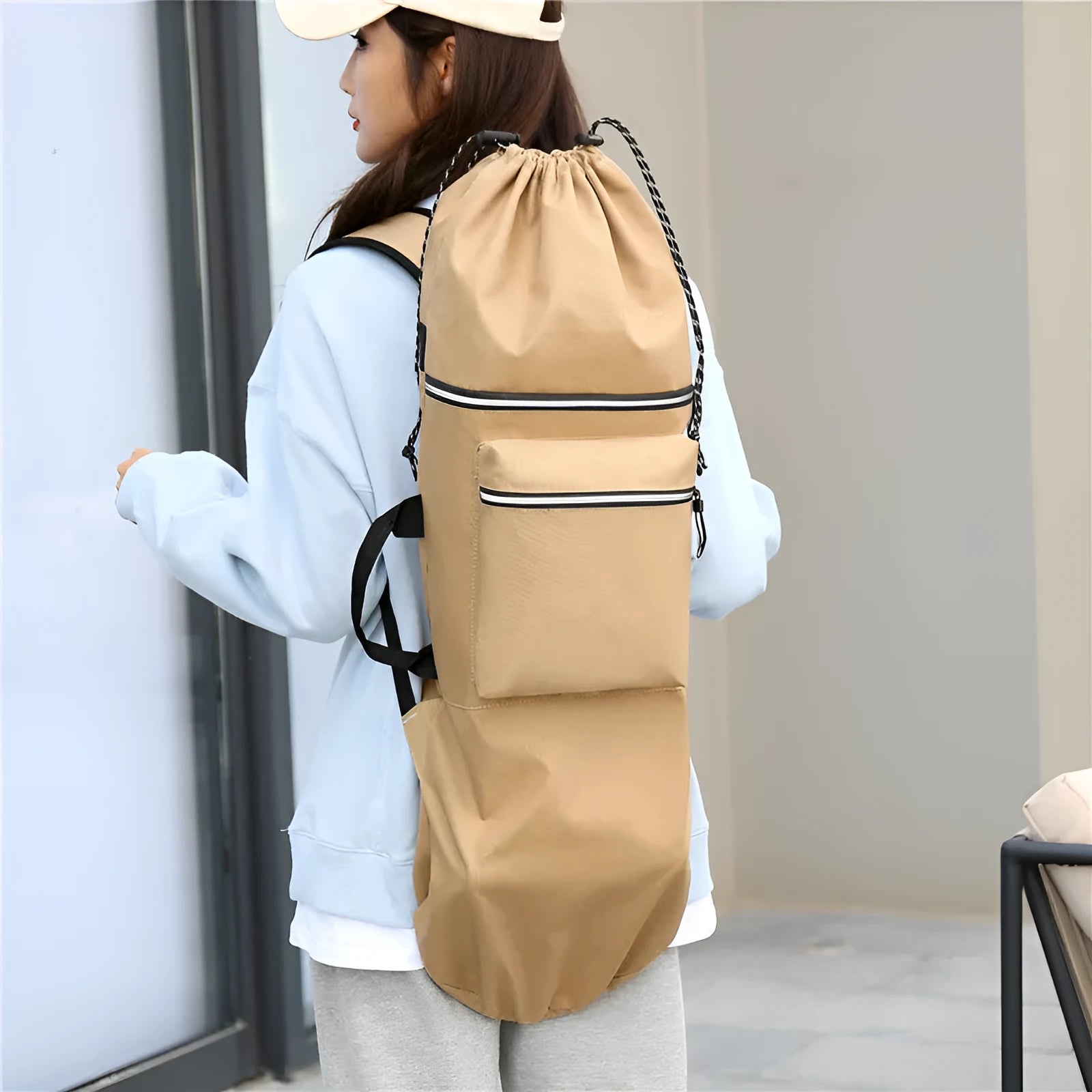 Black waterproof nylon skateboard bag holding a longboard, with yoga mat and fishing rod alternative uses shown.