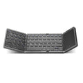 Three folding wireless Bluetooth keyboard with touch pad in black, open on a table next to a mobile phone