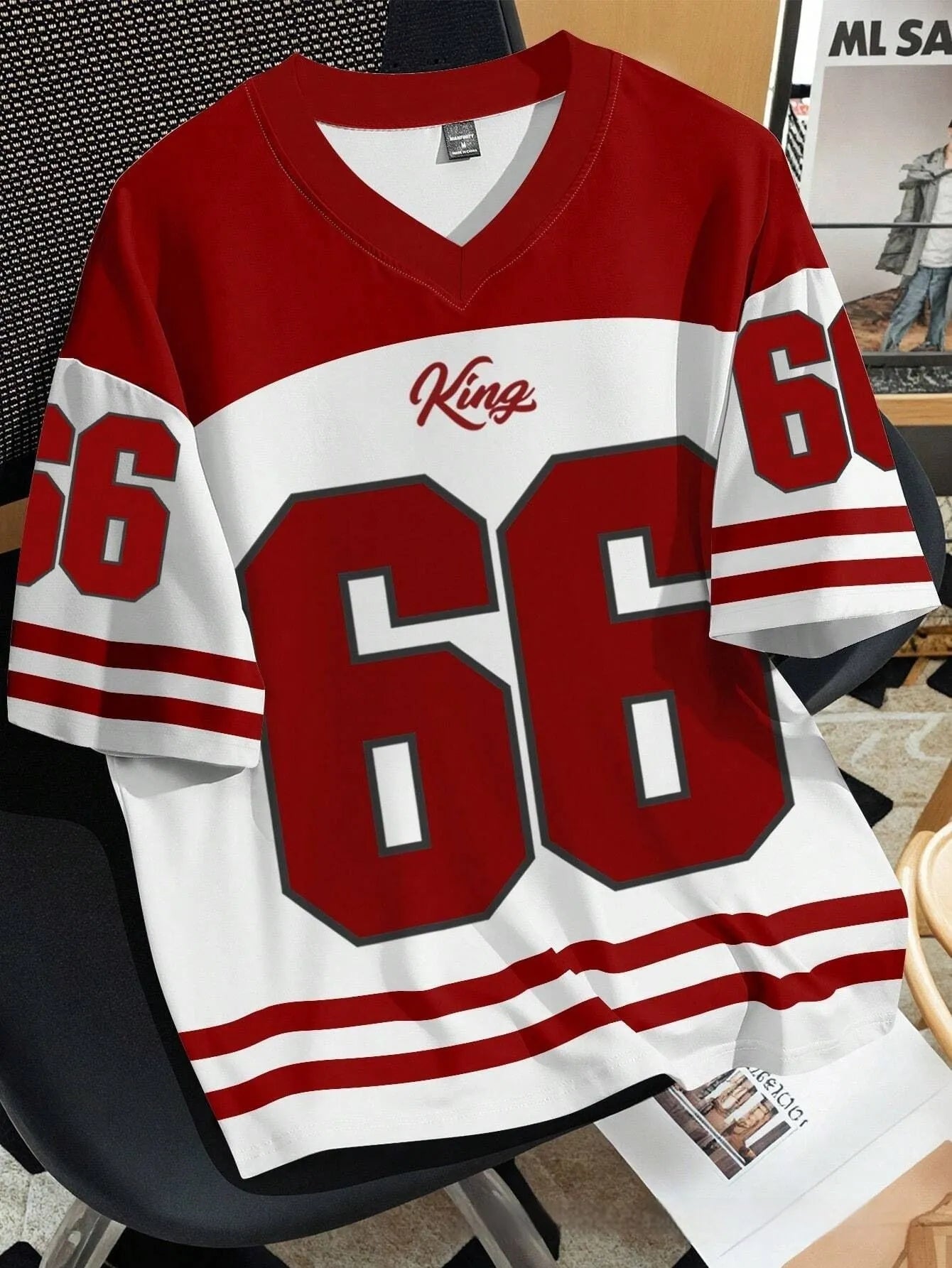 Man wearing a loose grey t-shirt with a large Chicago No. 23 digital print on the front.