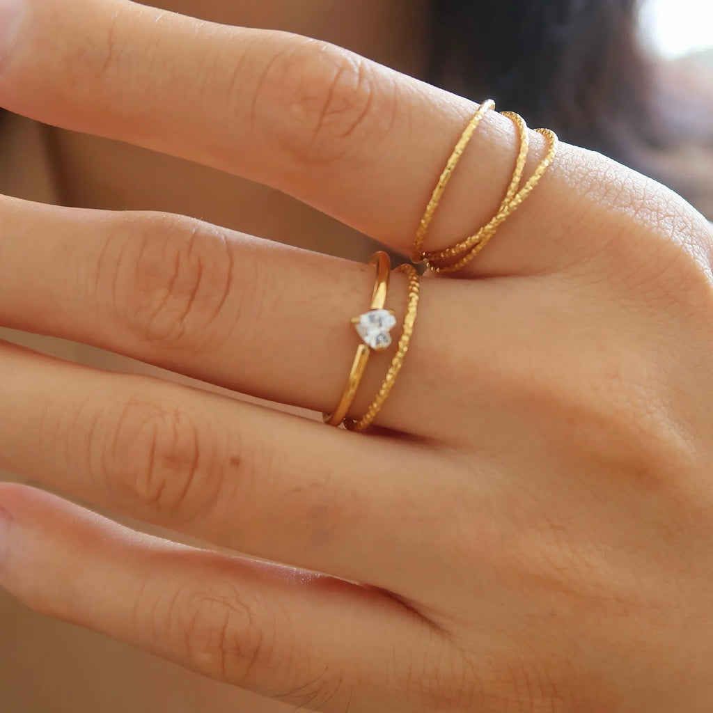 Simple golden electroplated stainless steel heart ring for women, shown in UK sizes 6, 7, 8.