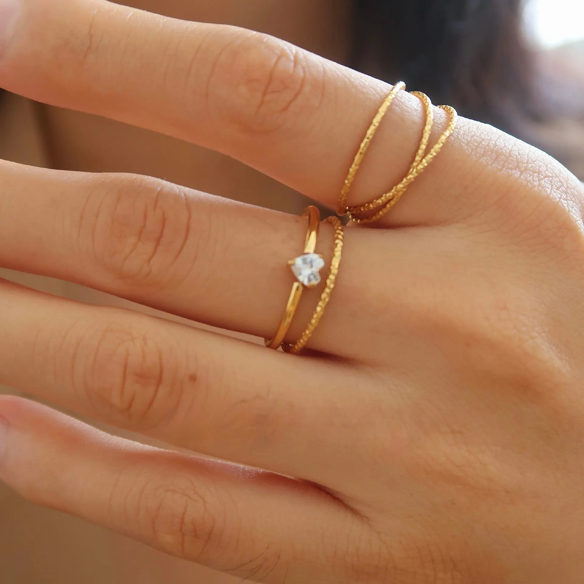 Simple golden electroplated stainless steel heart ring for women, shown in UK sizes 6, 7, 8.