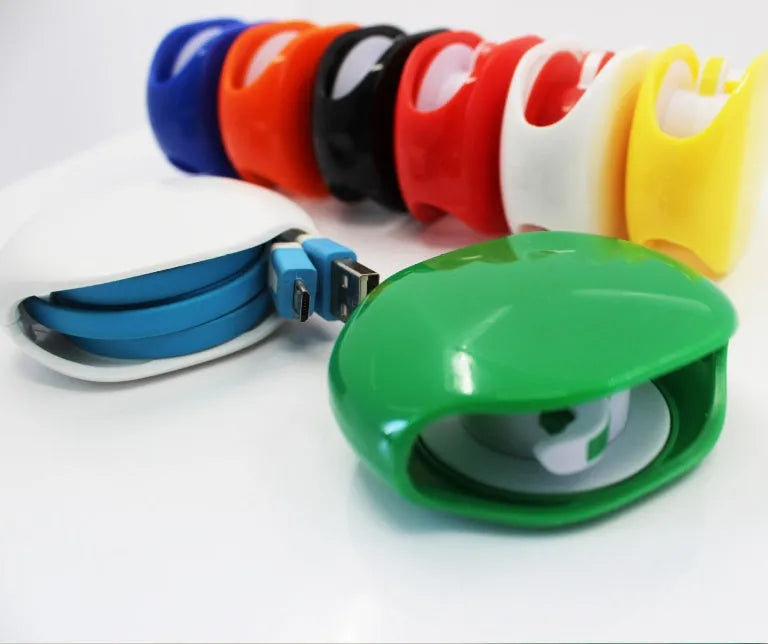 Automatic earphone cable winder retractor in blue, showing compact size next to a 3.5mm jack.