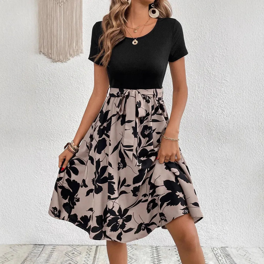 Women's khaki A-line dress with botanical printing, lace-up detail, and a shoulder strap.