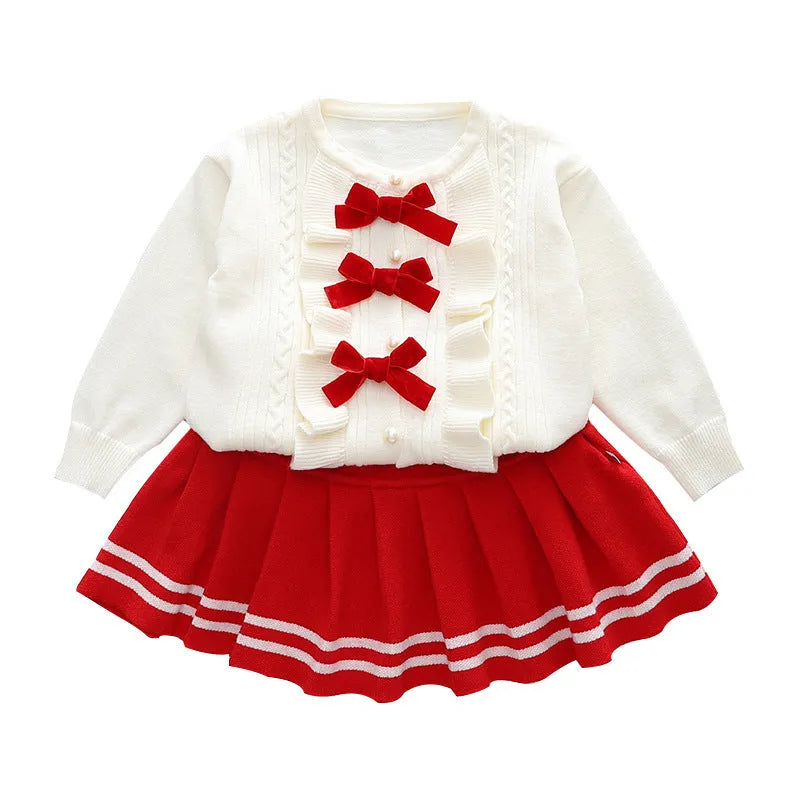 Knitted baby girl two-piece skirt suit in pink with bow detail and long sleeves, autumn wear
