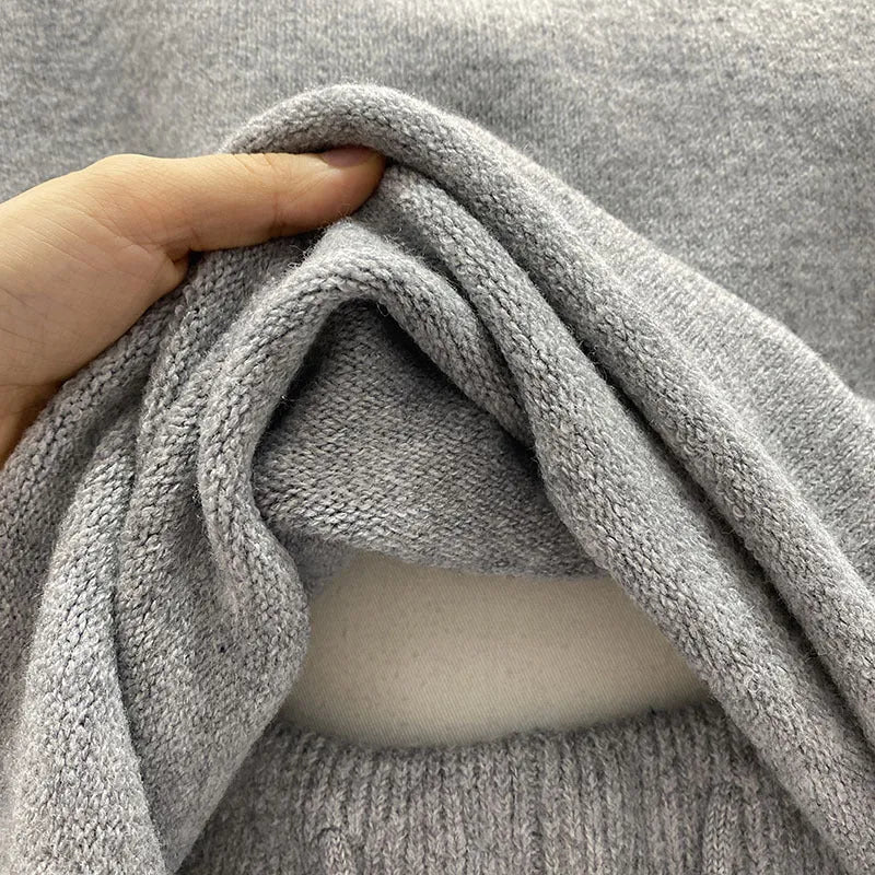 Women's loose grey acrylic knit sweater and wide-leg shorts set laid flat.