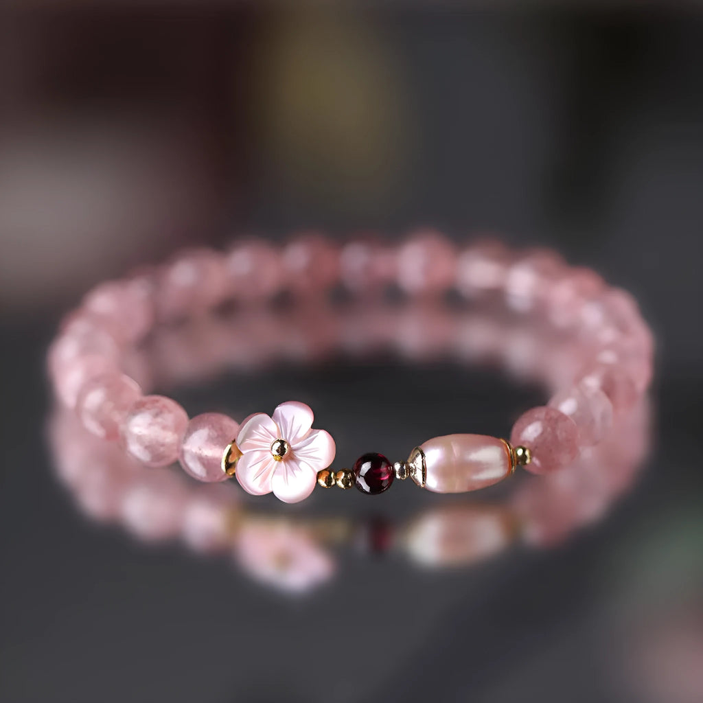 Light pink strawberry quartz crystal bracelet with peach blossom floral design and adjustable fastening