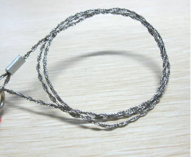 Stainless steel survival wire saw with ring attachments showing 55cm cutting length