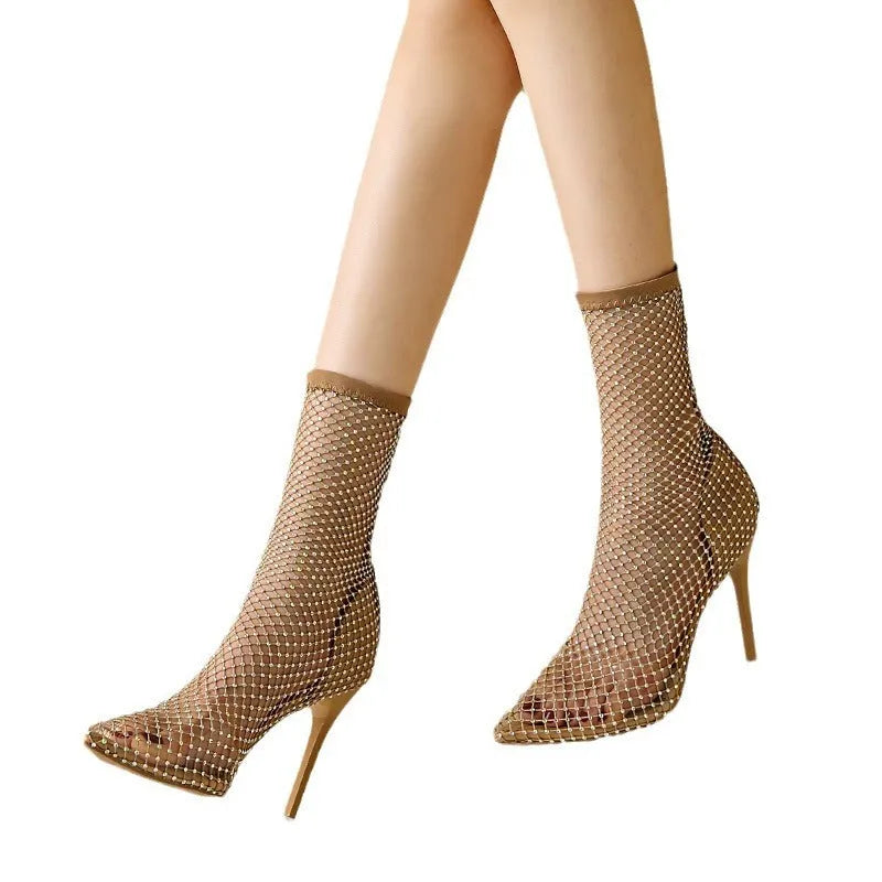 Gold coloured high heel sandals with a pointed toe and stiletto heel, featuring a mesh upper.