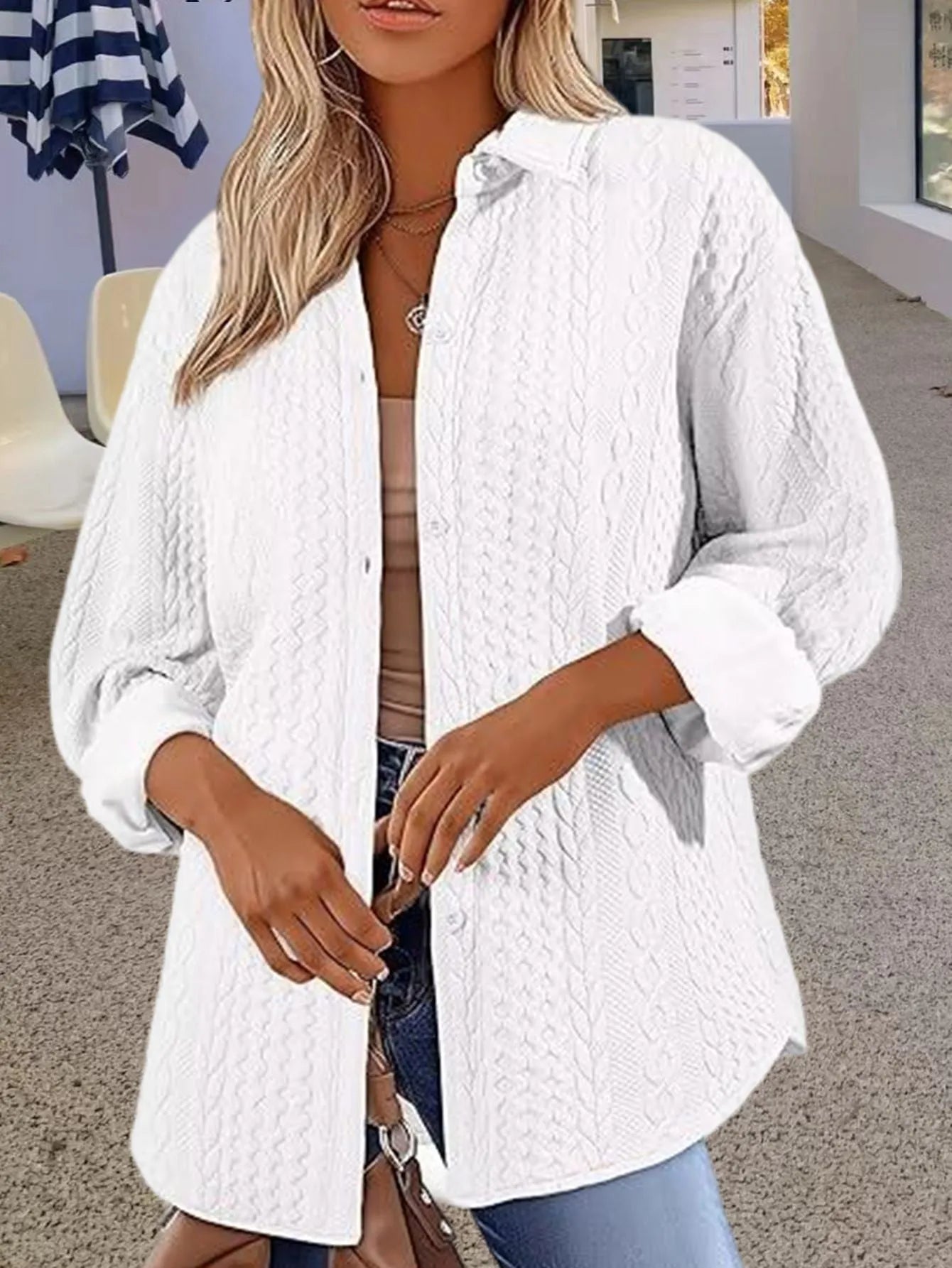 Women's solid colour knitted cardigan with long sleeves in black, shown on a model