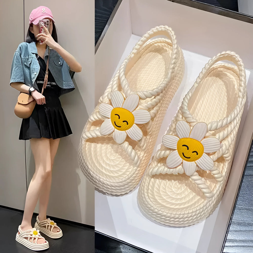 Women's PVC sandals with flower decorations in beige and black colours showing round-toe non-slip design
