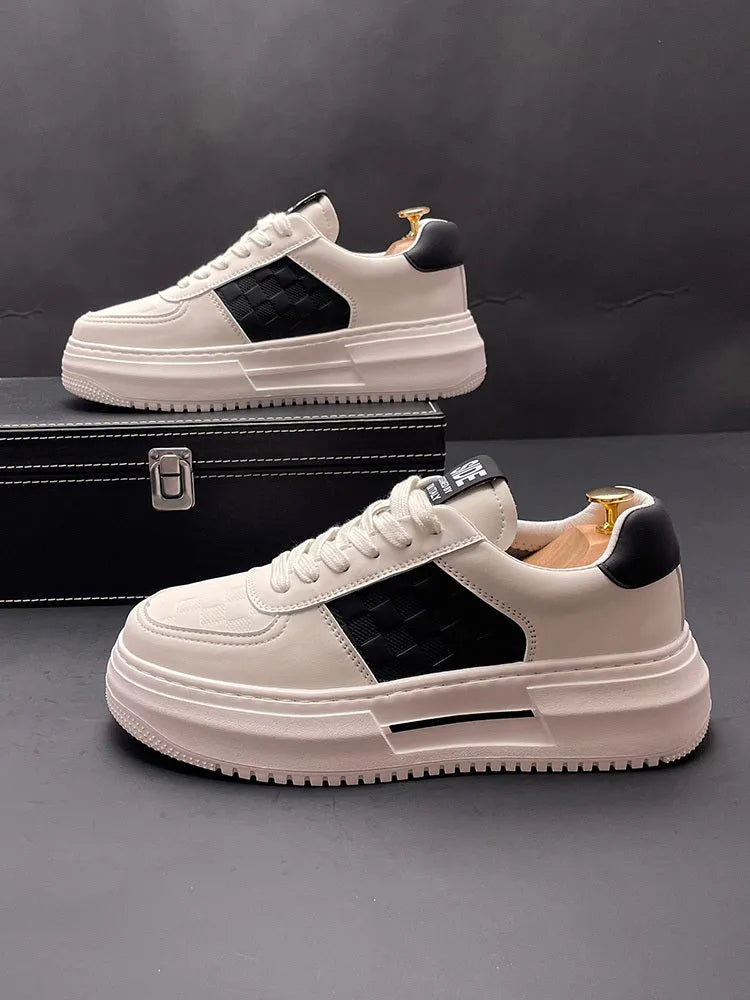 A pair of white green and white black unisex cloth sports casual shoes with a rubber foam sole.