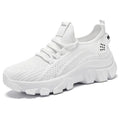 Women's white Flyknit running sneakers with a round toe and flat PVC sole, shown with lace-up front.