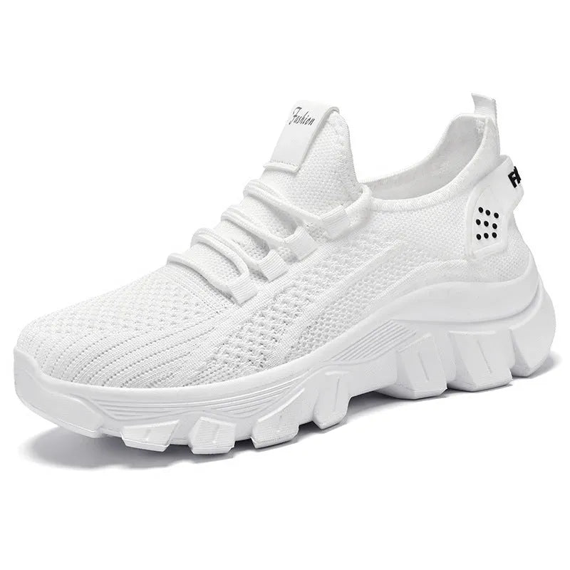 Women's white Flyknit running sneakers with a round toe and flat PVC sole, shown with lace-up front.