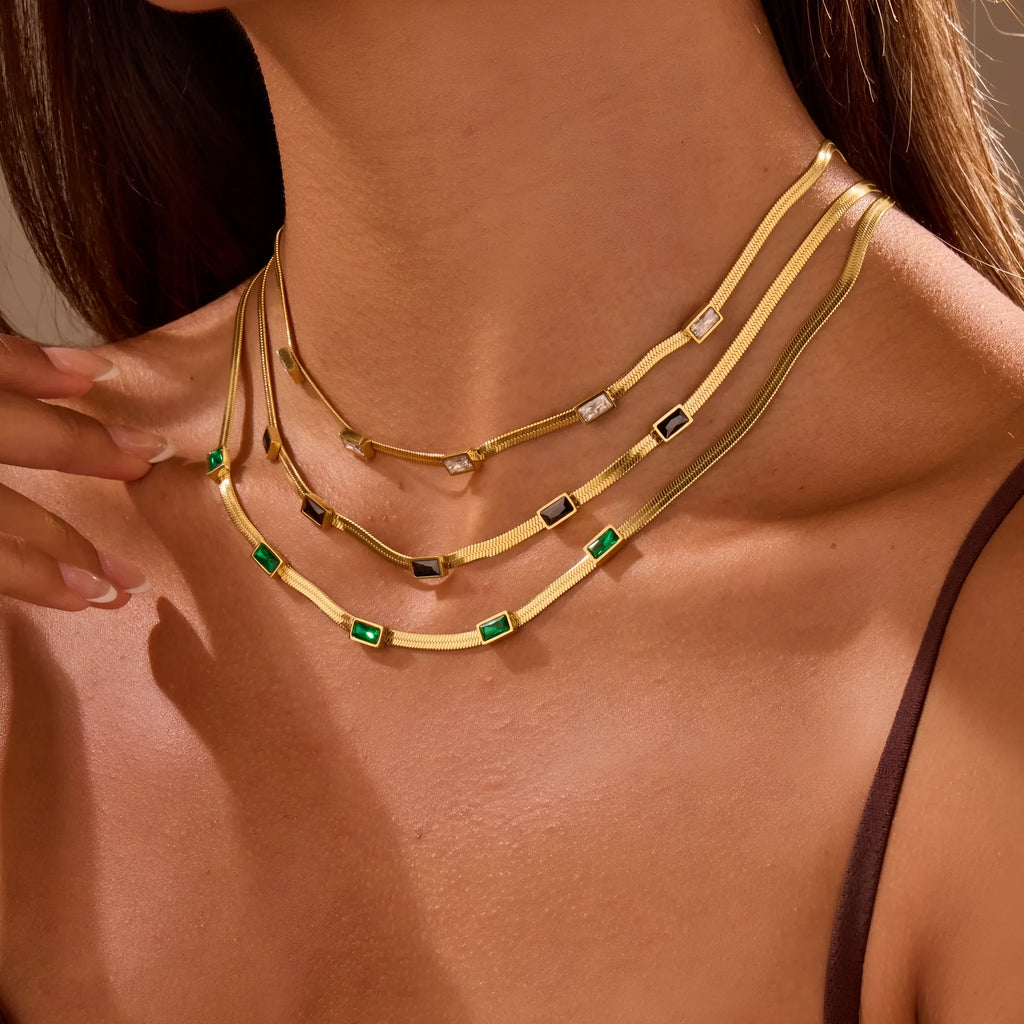 Geometric square zircon pendant on a flat stainless steel snake chain necklace in gold or steel colour.