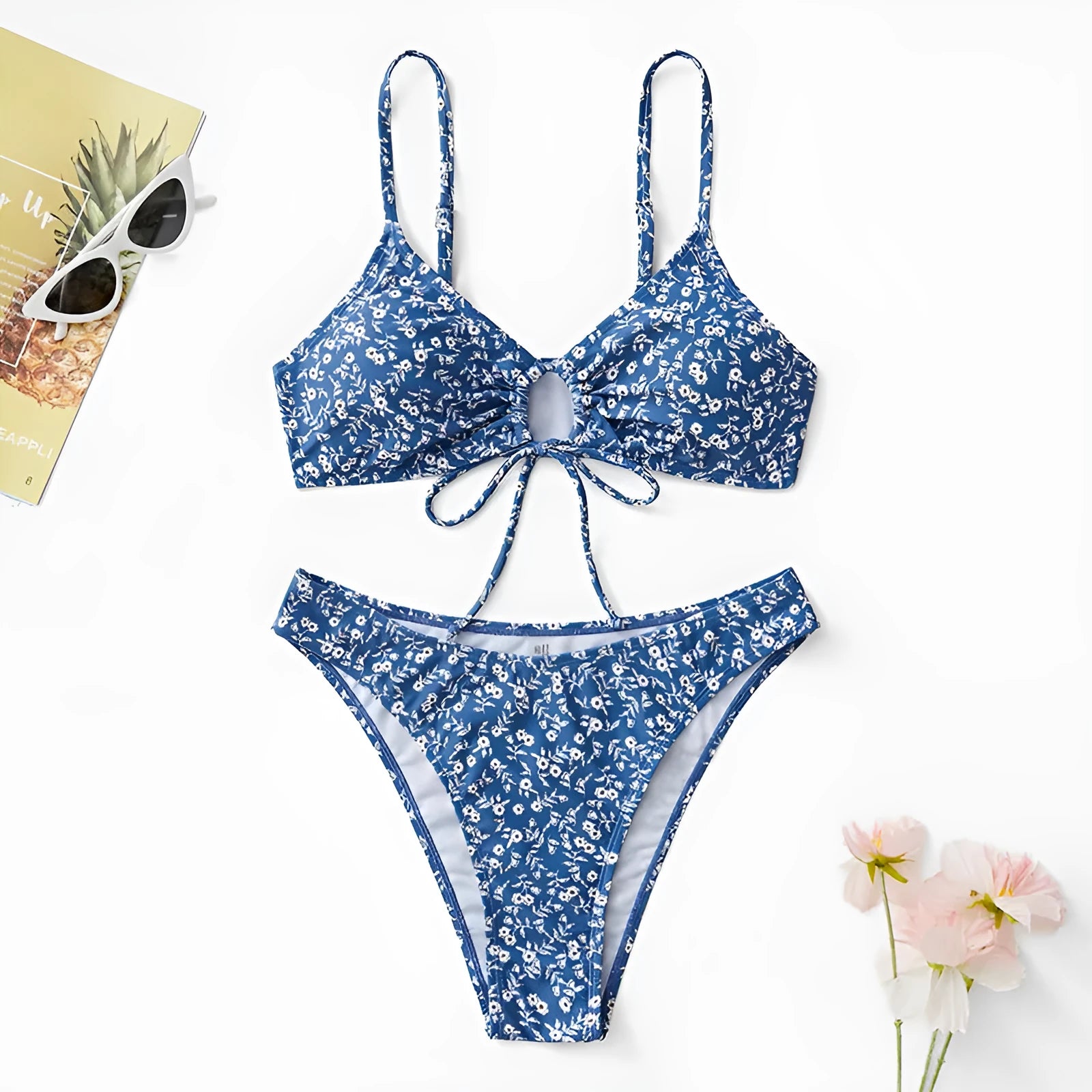 Blue women's swimsuit three-piece set featuring a top and shorts, made from polyester fabric.