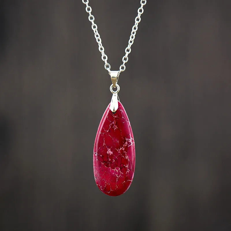 Emperor Stone water drop pendant necklace with genuine jade centre and 18K gold plated setting on a chain.