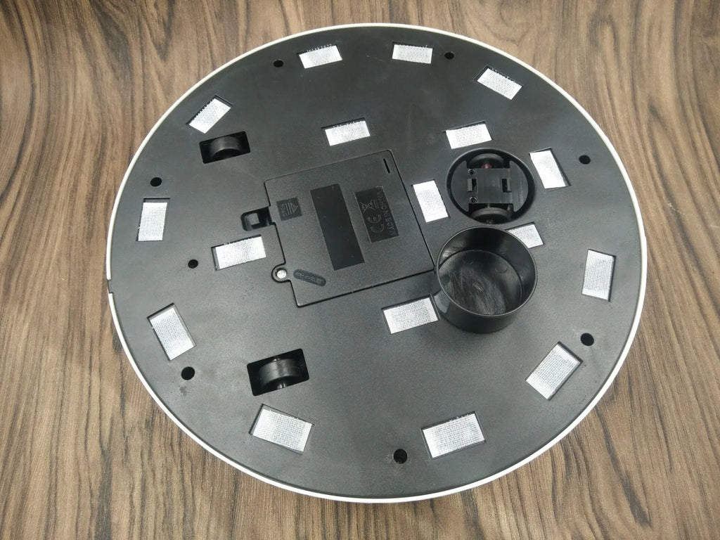 AC automatic sweeping robot vacuum cleaner in black or white on a hard floor