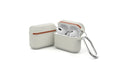 Beige silicone clamshell case for Apple AirPods with a metal buckle attached.