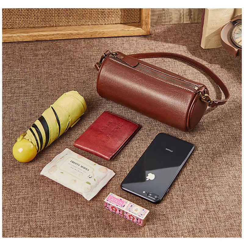 Top layer cowhide leather round single-shoulder bag in caramel brown with wide strap and sewing thread details