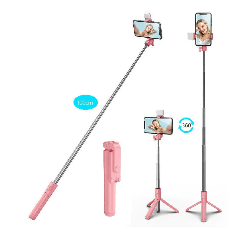 Black Bluetooth selfie stick with fill light and extended tripod legs holding a smartphone.