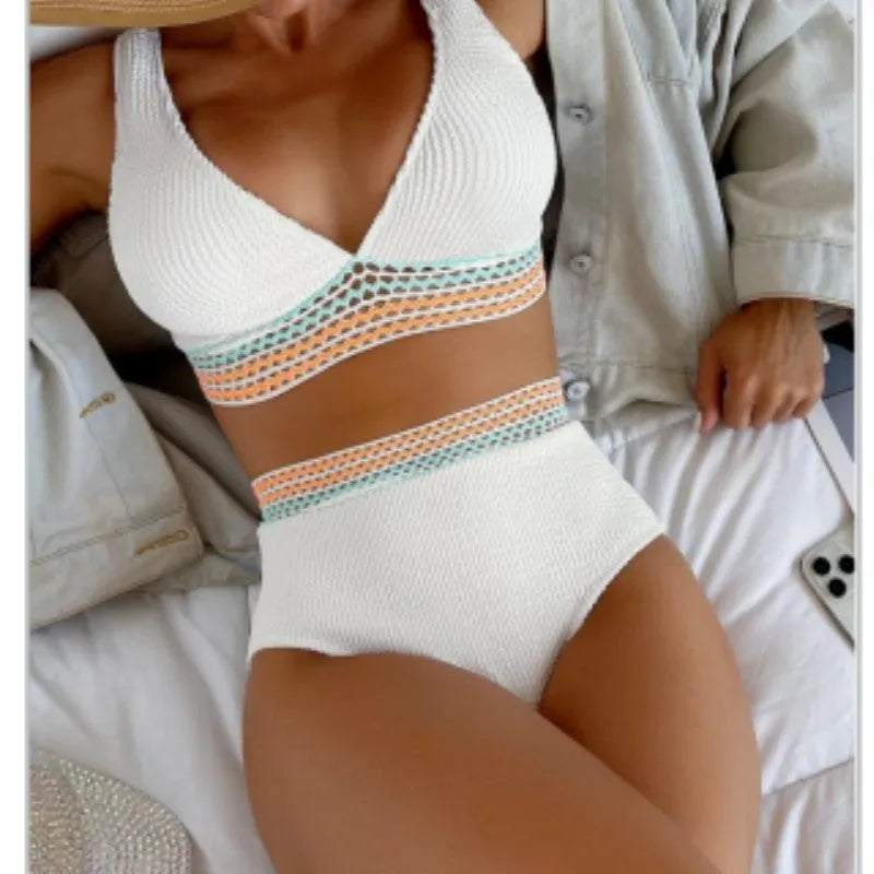 A pink high waist women's bikini brief with a split leg design, laid flat.