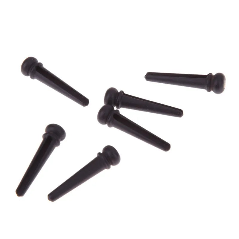 Six matt black ebony wood guitar string nails for folk acoustic guitars.