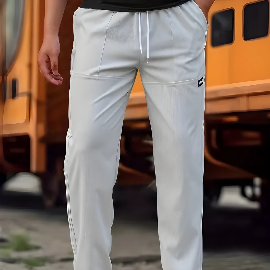 Men's light grey polyester casual trousers for spring and autumn wear.