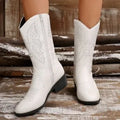Women's black punk-style mid-calf boots with a chunky heel, pointed toe, and hollow-out details on the PU upper.