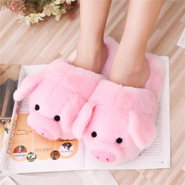 Pink pig character plush floor slippers on a white background