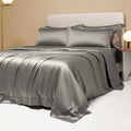 A modern, neatly made bed with a Lenzing Tencel duvet cover and pillowcases in a choice of nine colours like Sea Salt Blue.