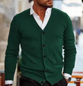 A man wearing a slim-fit, long-sleeve acrylic cardigan sweater coat in a dark green colour.