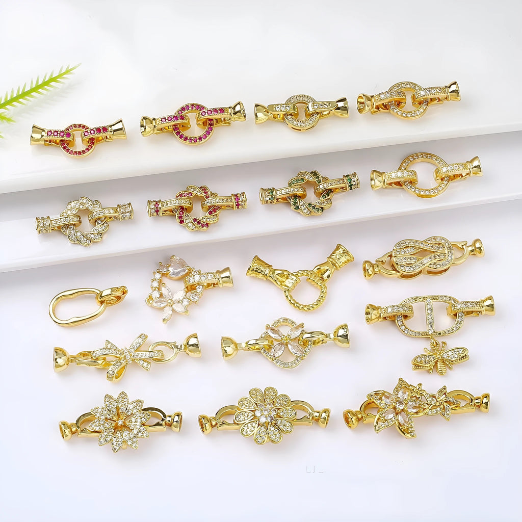 Small gold-colour electroplated metal jewellery buckle clasp on a white background.