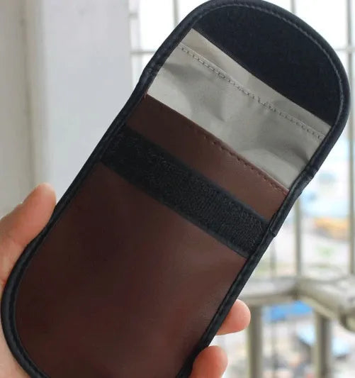 Black microfiber Faraday pouch for blocking car key, phone, and bank card signals.