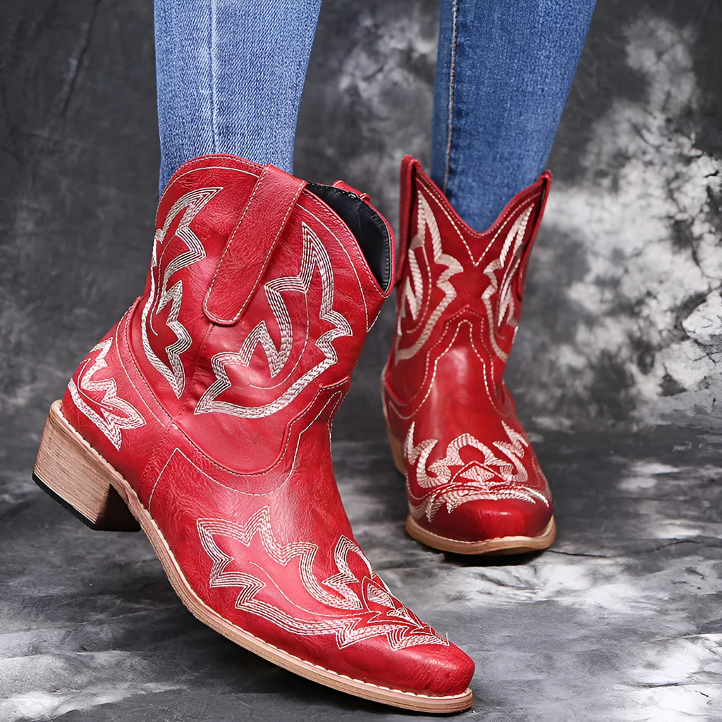 Women's blue embroidered Western ankle boots with a low wedge heel and pointed toe