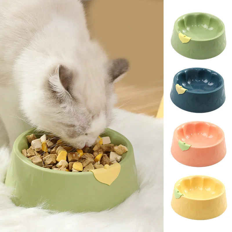 Green plastic double pet bowl for cats and small dogs on a floor.